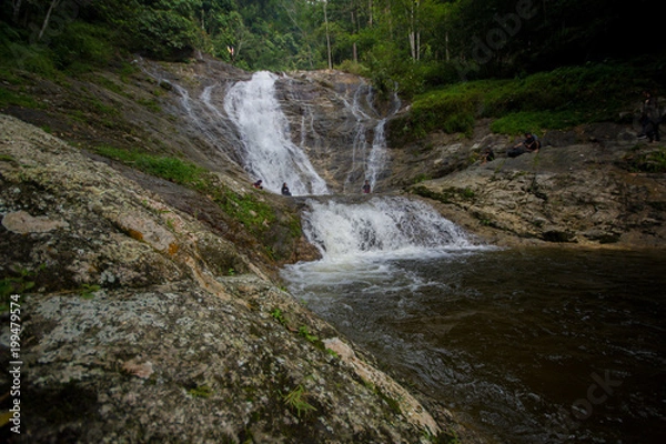 Fototapeta Lata Iskandar, Perak, Malaysia. March 25, 2018. A lady taking a rest at a Lata Iskandar waterfall, located along a trunk road from Tapah to Cameron Highland.