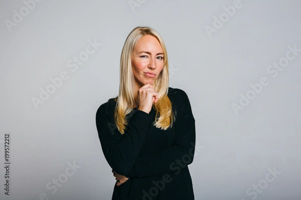 Fototapeta Woman disgust while standing against grey background.