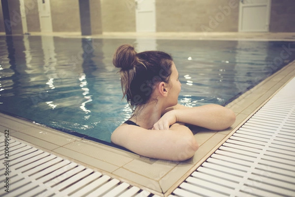 Fototapeta Beautiful young woman at swimming pool