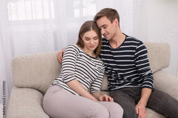 Fototapeta I love you. Happy loving man and woman sitting together and hugging