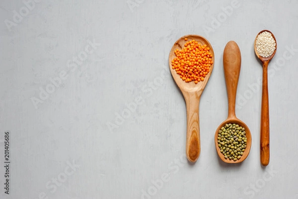 Fototapeta Three spoons of handmade. Wooden spoons with lentils and other grains.