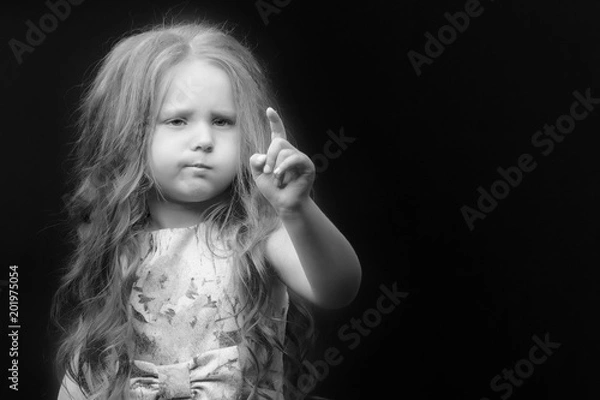 Fototapeta Little girl on a black background