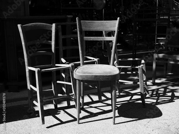 Fototapeta  Second hand chairs for sale at the market. Black and white photo.