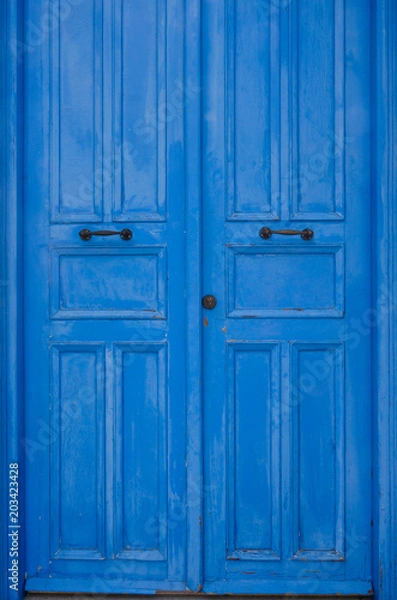 Fototapeta Blue door in Mediterranean style. Traditional greek door in Cyprus. Vintage background, texture. Copy space