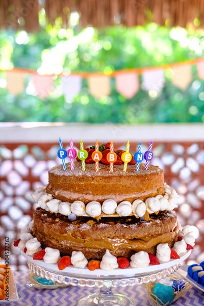 Fototapeta detail of strawberry and meringue naked cake, seen from above, 3 stories high