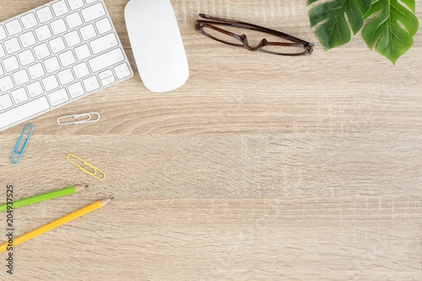 Fototapeta Flat lay photo of office desk with mouse and keyboard ,Top view workpace on wood table and copy space