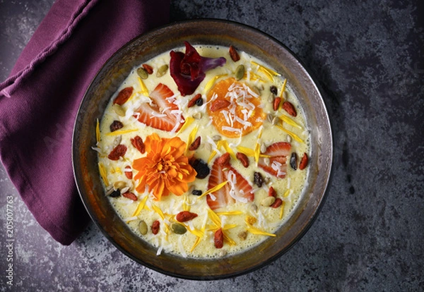 Fototapeta mango smoothie bowl on concrete table