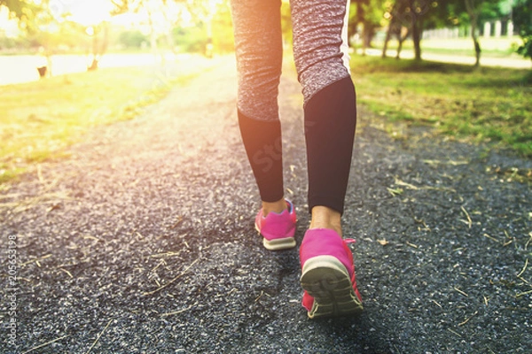 Fototapeta close up leg woman running with sunset