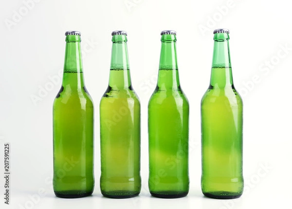 Fototapeta Four bottles of beer isolated on white background