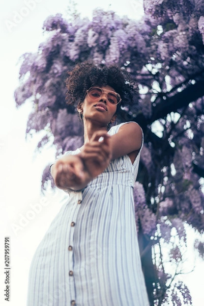 Obraz Happy young black woman surrounded by flowers