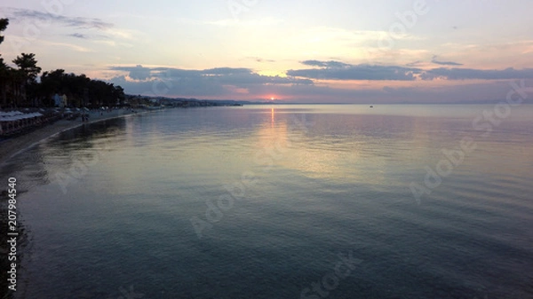 Fototapeta flight over the sea at sunset