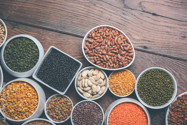 Obraz Uncooked pulses,grains and seeds in White bowls over wooden background. selective focus