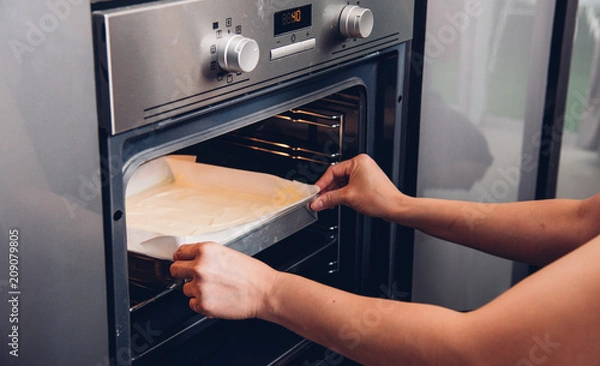 Fototapeta Hands woman female bakery holding bread fresh on front oven