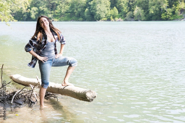 Fototapeta Woman playing near river