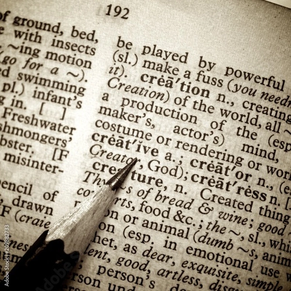 Fototapeta Black pencil point on creative word on old dictionary