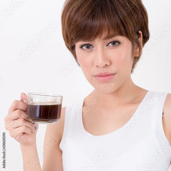 Fototapeta Beautifulyoung Asia woman with a cup of hot coffee. Isolated on white background. Studio lighting. Concept for healthy.