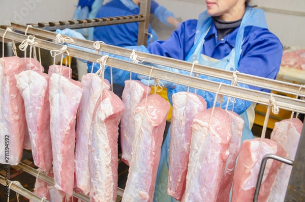 Fototapeta Pork. The line for the production of smoked delicacies. Industrial manufacture of sausage products. Smokehouse of meat products