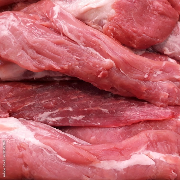 Fototapeta Pieces of fresh raw pork tenderloin closeup, may be used as background or texture