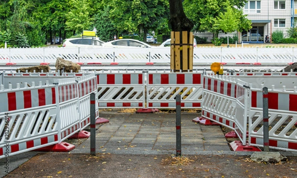 Obraz On a construction site trees are protected with boards
