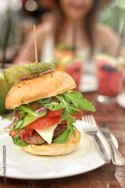 Fototapeta Plate with tasty fresh burger on table