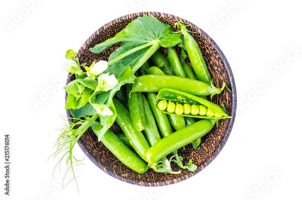 Fototapeta Wooden bowl with pods of green peas