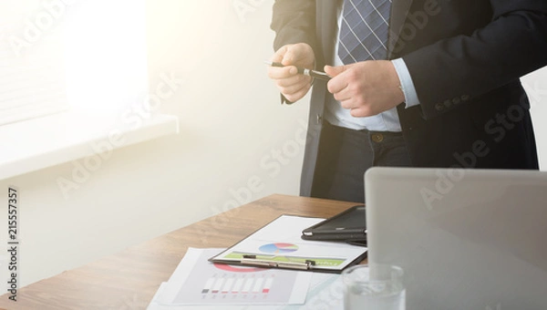 Fototapeta young businessman in office with smartphone tablet at workplace