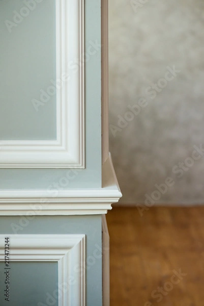 Fototapeta Gray column with white molding. Texturized grey putty. Vintage or grungy background of venetian stucco texture as pattern wall.