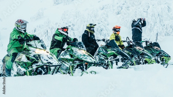 Fototapeta Snowmobile riders lined up ready to go