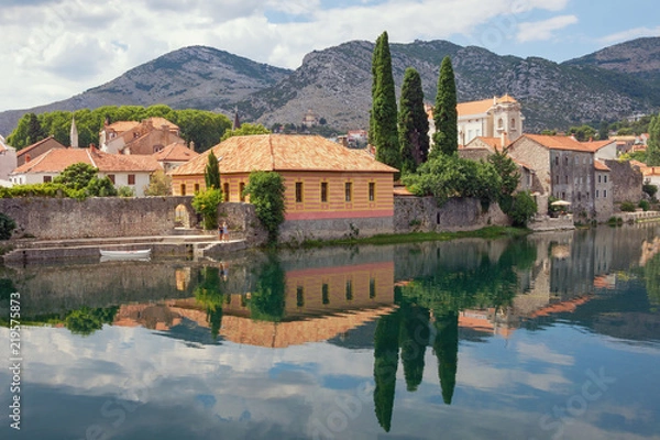 Fototapeta Beautiful ancient town on river bank. Bosnia and Herzegovina, view of Trebisnjica river and Old Town of Trebinje