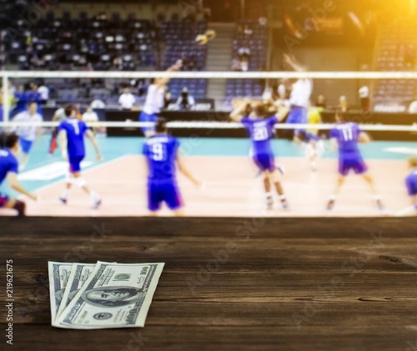 Obraz Money dollars on the background of a TV on which show volleyball, sports betting, dollars