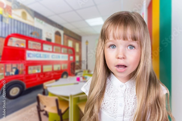 Fototapeta Portrait of a little school girl in a class