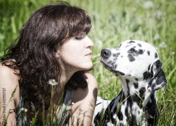 Fototapeta Pretty beautiful woman with long dark hair with dalmatian dog