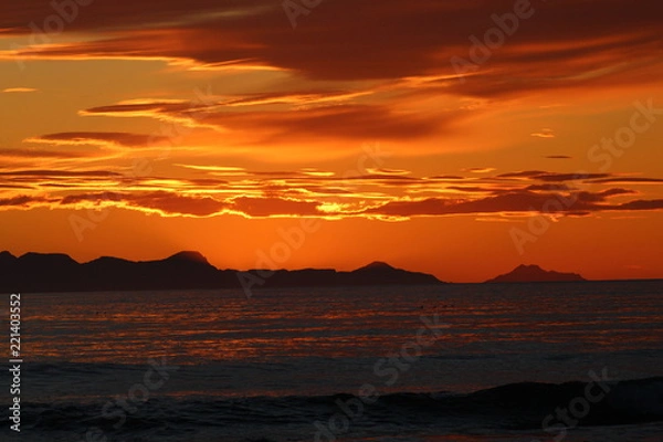 Fototapeta Scenic sunset in Iceland, with orange burning sky. Zoom lens.