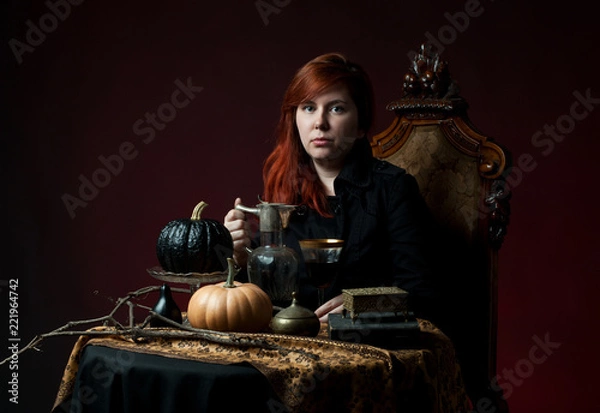 Fototapeta Young woman with red hair drinking wine