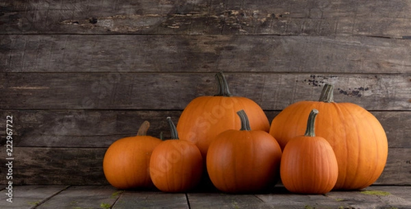 Fototapeta Pumpkins on wooden background