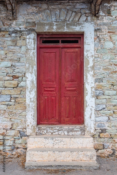 Obraz Red door of stony house