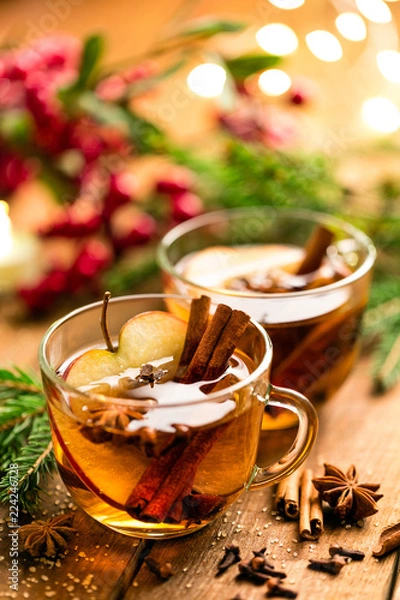 Fototapeta Mulled cider with cinnamon, cloves and anise. Traditional Christmas drink