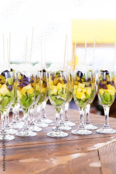 Fototapeta Cuts of fruits in glasses for party