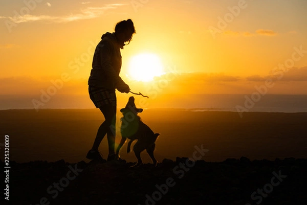 Fototapeta girl playing with her puppy dog