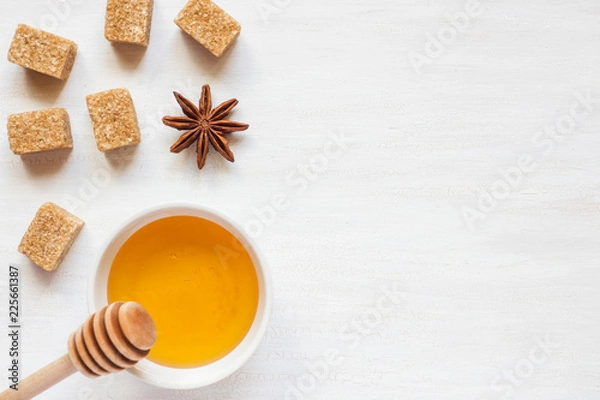 Fototapeta Honey, brown sugar and star anise on a light background Copy space for text.