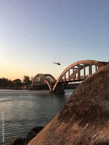 Fototapeta Helicopter above a brigde