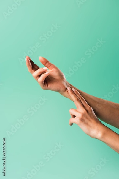 Fototapeta cropped shot of person checking pulse isolated on green