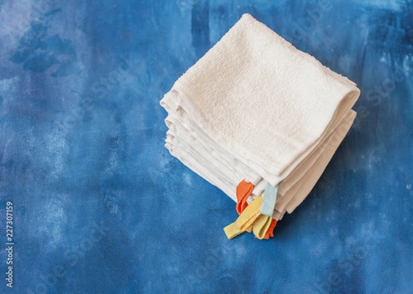 Fototapeta white towel on blue background . White Spa towels on blue background, top view