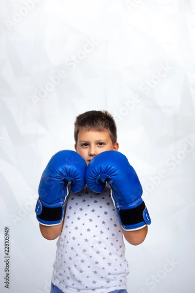 Fototapeta Portrait of a sporty boy engaged in boxing.