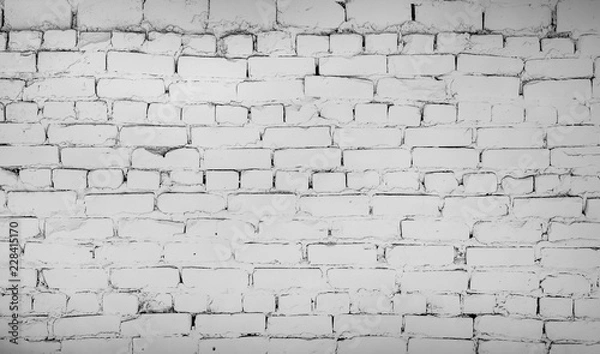 Obraz Light white black and gray horizontal brick wall. Old uneven textured surface on a building in the city. Urban background in grayscale. White painted bricks.