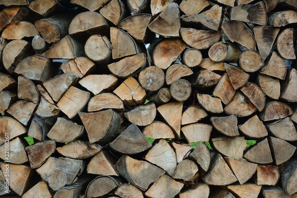 Fototapeta Firewood stacked for storage. Store firewood. Wood burned as fuel.