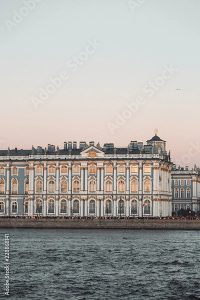 Fototapeta The formal architecture of St. Petersburg. The bridges and the river Neva embankment. Sunset over the city.