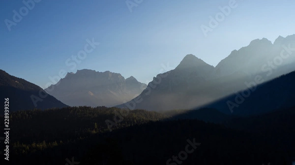 Fototapeta Austria, Tyrolean Alps. Road to Fern pass. Wonderful landscape at the mountain and wood during sunrise. The Zugspitze peak on the back