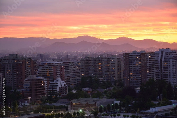 Obraz Sunset clouds and cityscape