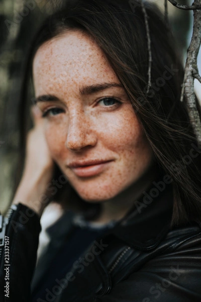 Fototapeta Portrait of a young woman with freckles